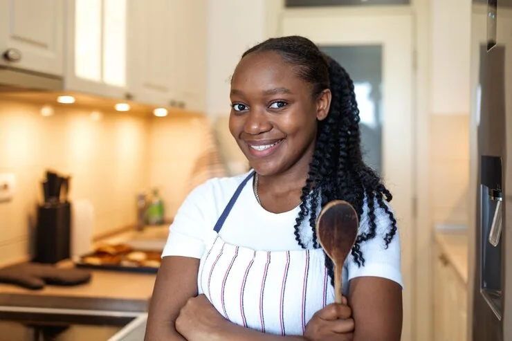 Home-based food business owner standing in her kitchen