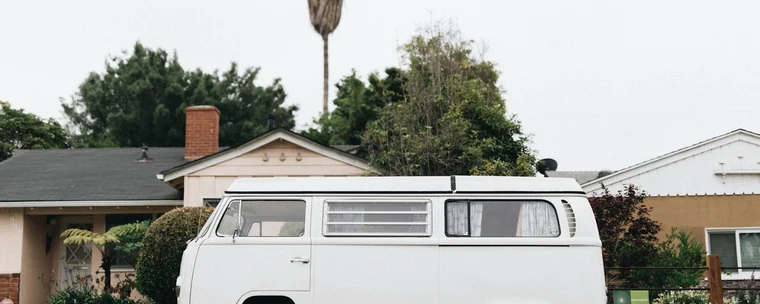 White van parked in front of a neighborhood home